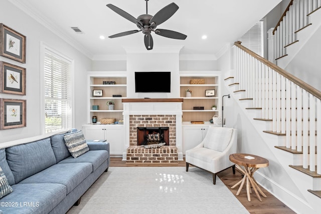 7 Canton Row, Beaufort, SC 29906 - living room with wood finished floors, stairs, a fireplace, crown molding, and ceiling fan
