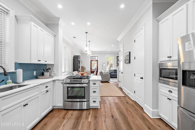 7 Canton Row, Beaufort, SC 29906 - kitchen featuring appliances with stainless steel finishes, recessed lighting, crown molding, open floor plan, and white cabinetry