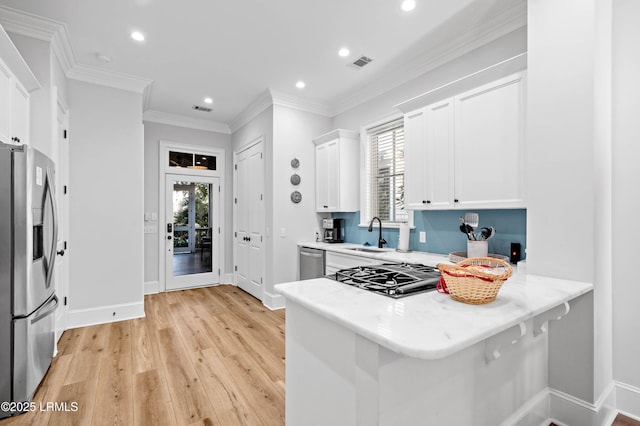 7 Canton Row, Beaufort, SC 29906 - kitchen featuring stainless steel appliances, recessed lighting, white cabinetry, light wood finished floors, and a peninsula