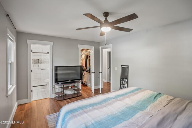 702 Center Dr W, Beaufort, SC 29902 - bedroom with wood finished floors, baseboards, a walk in closet, a closet, and ceiling fan