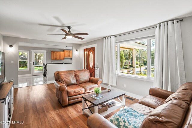 702 Center Dr W, Beaufort, SC 29902 - living area with ceiling fan, plenty of natural light, light wood finished floors, and baseboards