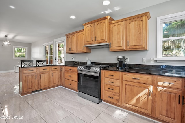 702 Center Dr W, Beaufort, SC 29902 - kitchen with stainless steel gas range, a peninsula, dark stone counters, under cabinet range hood, and recessed lighting