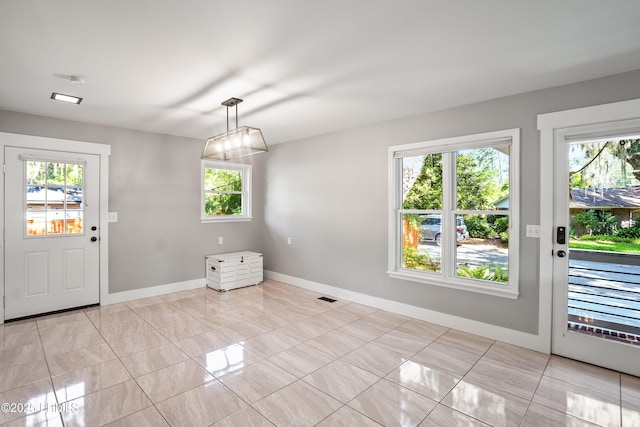 702 Center Dr W, Beaufort, SC 29902 - unfurnished dining area with healthy amount of natural light and baseboards