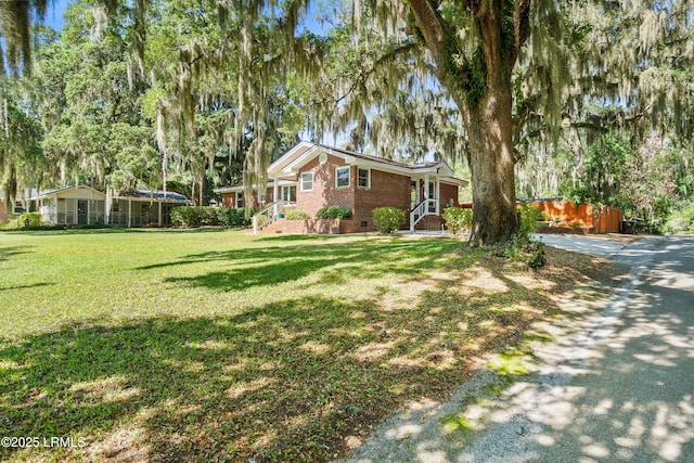 702 Center Dr W, Beaufort, SC 29902 - view of front facade featuring brick siding, crawl space, and a front lawn