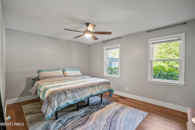 702 Center Dr W, Beaufort, SC 29902 - bedroom featuring baseboards, wood finished floors, and ceiling fan