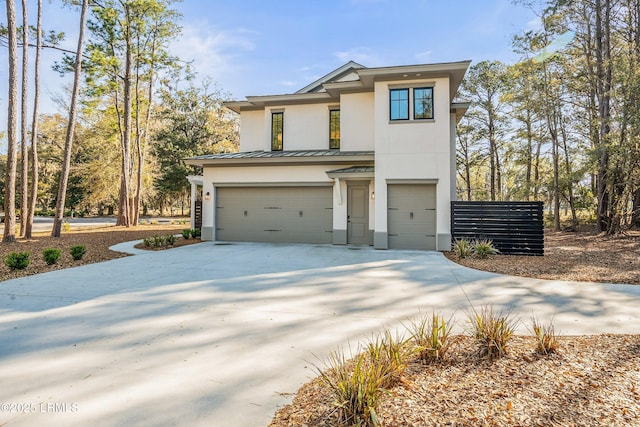 view of front of house featuring a standing seam roof, metal roof, driveway, a garage, and stucco siding