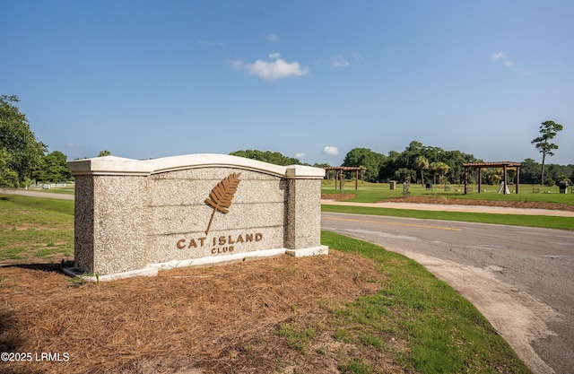 community sign featuring a lawn