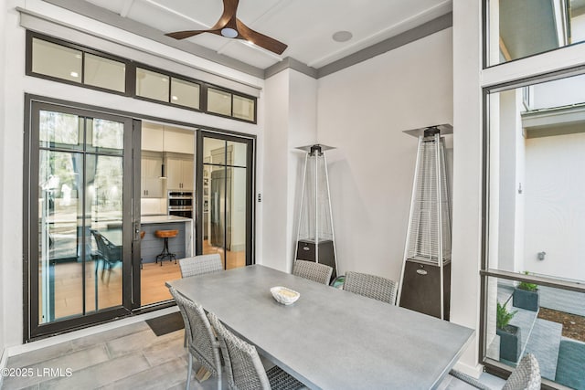 interior space featuring a ceiling fan and outdoor dining space