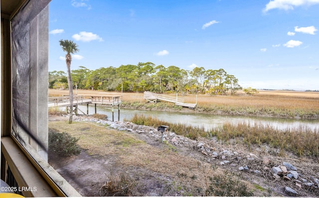 property view of water with a dock and a rural view