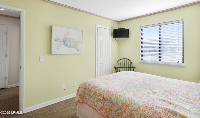 bedroom with crown molding and a closet