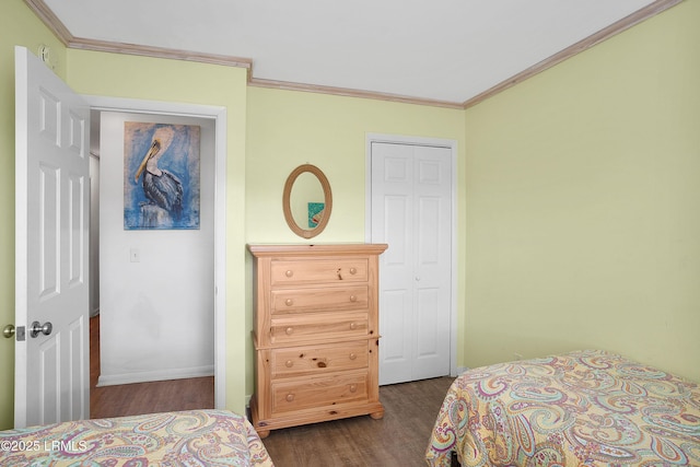 bedroom featuring crown molding and dark hardwood / wood-style flooring