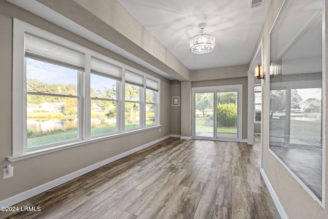 unfurnished sunroom featuring a notable chandelier