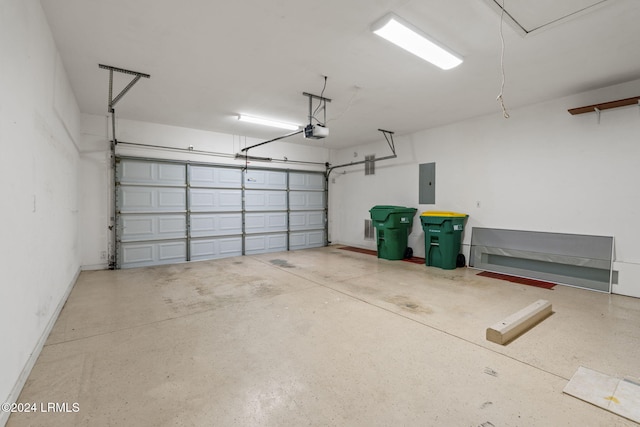 garage with a garage door opener and electric panel