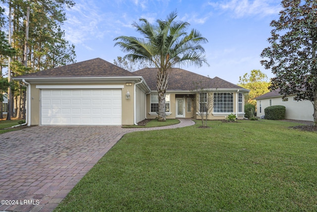 ranch-style house with a garage and a front lawn