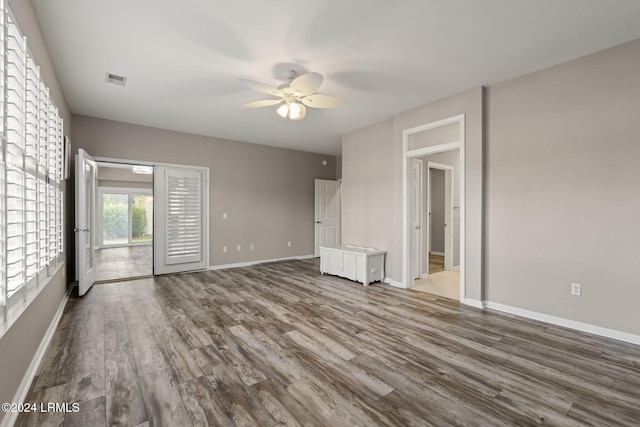 interior space with wood-type flooring and ceiling fan