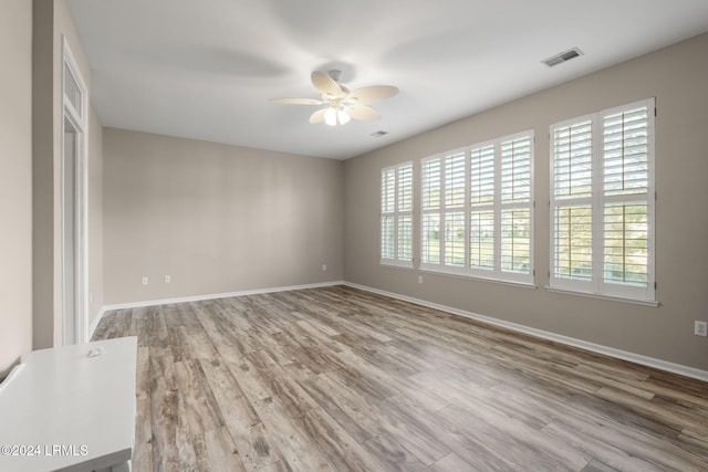 spare room featuring hardwood / wood-style flooring and ceiling fan