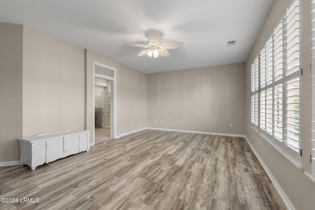 empty room featuring light hardwood / wood-style flooring and ceiling fan