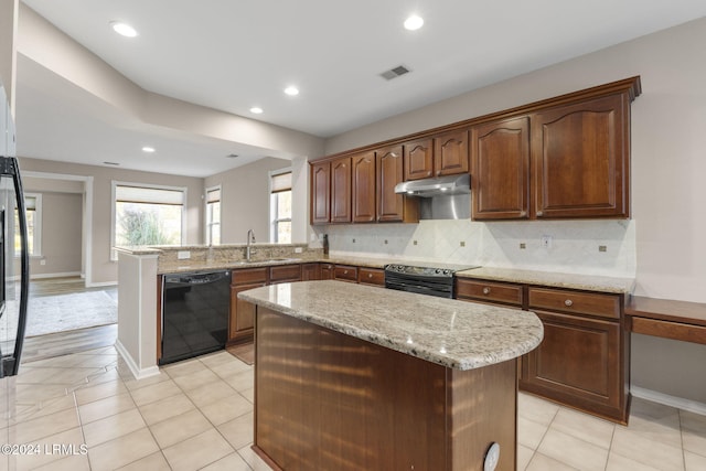 kitchen featuring a kitchen island, tasteful backsplash, black dishwasher, sink, and electric stove