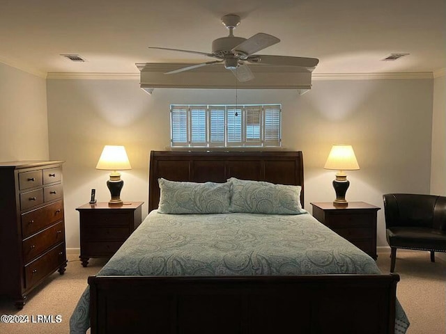 carpeted bedroom with ornamental molding and ceiling fan