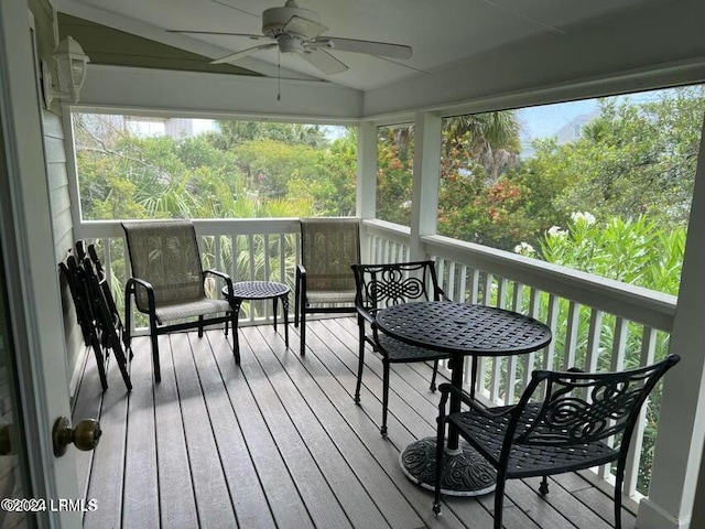 wooden deck featuring ceiling fan