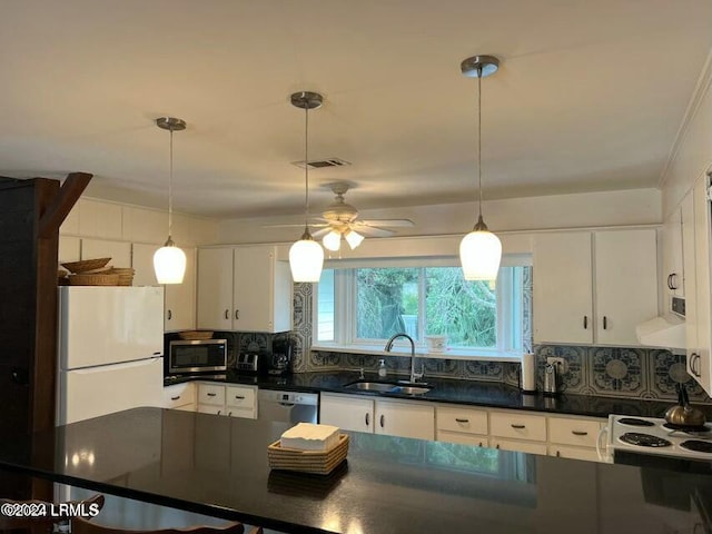 kitchen with white cabinetry, sink, backsplash, hanging light fixtures, and stainless steel appliances