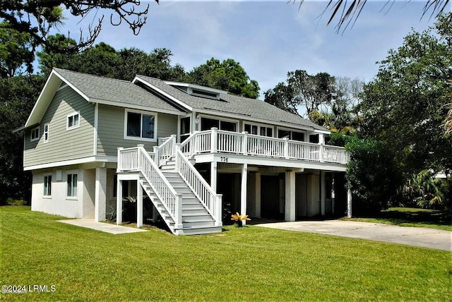 rear view of house featuring a lawn and a carport