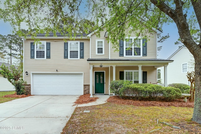 85 Pine Ridge Dr, Bluffton, SC 29910 - traditional-style house featuring brick siding, a porch, driveway, and an attached garage