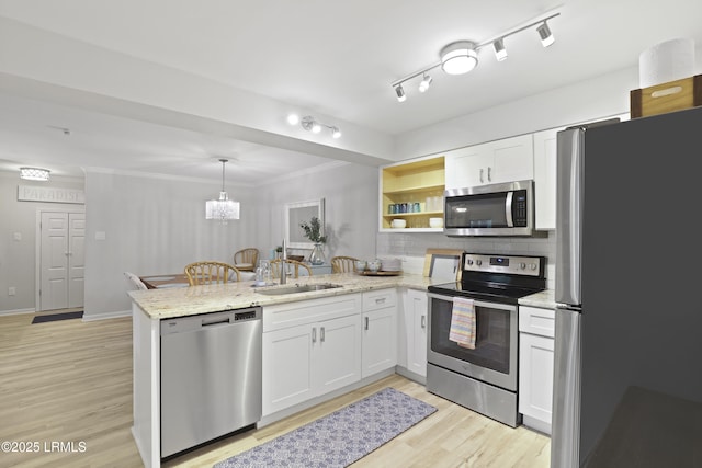 7 Three Mast Ln Unit 7, Hilton Head Island, SC 29928 - kitchen with appliances with stainless steel finishes, a peninsula, a sink, open shelves, and white cabinets
