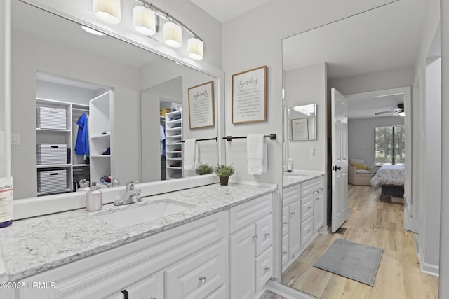 7 Three Mast Ln Unit 7, Hilton Head Island, SC 29928 - ensuite bathroom with vanity, wood finished floors, a ceiling fan, and a walk in closet