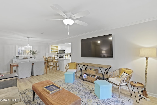 7 Three Mast Ln Unit 7, Hilton Head Island, SC 29928 - living room featuring ornamental molding, light wood-type flooring, a ceiling fan, baseboards, and a chandelier