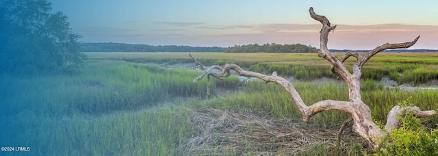 nature at dusk featuring a water view and a rural view