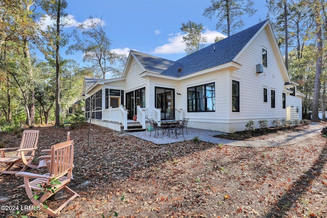 rear view of house featuring a patio area and a sunroom