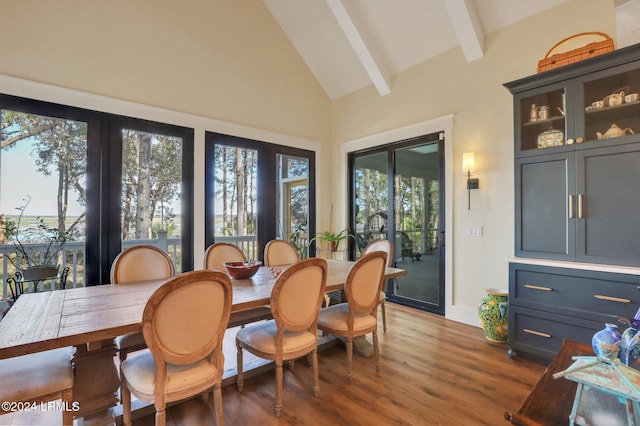 sunroom featuring vaulted ceiling with beams and a wealth of natural light