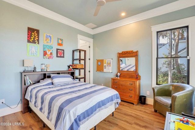 bedroom featuring crown molding, light hardwood / wood-style flooring, and ceiling fan