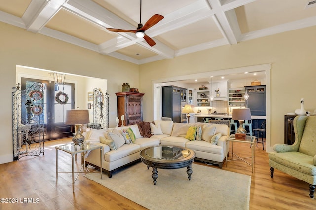 living room featuring coffered ceiling, beam ceiling, light hardwood / wood-style floors, and ceiling fan