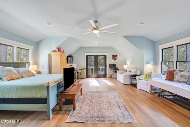 bedroom featuring lofted ceiling, light hardwood / wood-style floors, french doors, and ceiling fan