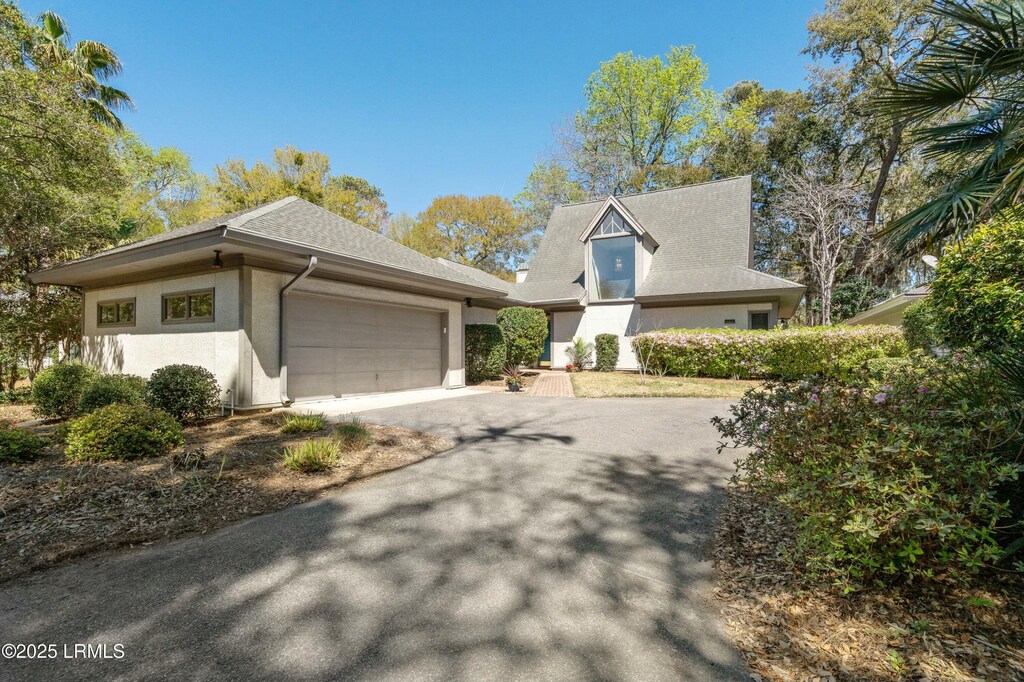 503 Bb Sams Dr, Saint Helena Island, SC 29920 - view of front of home featuring a garage, aphalt driveway, and stucco siding