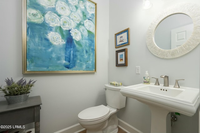 277 Pleasant Point Dr, Beaufort, SC 29907 - half bath featuring baseboards, toilet, and a sink