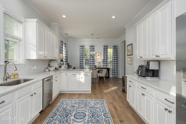 277 Pleasant Point Dr, Beaufort, SC 29907 - kitchen featuring a sink, appliances with stainless steel finishes, healthy amount of natural light, white cabinets, and recessed lighting