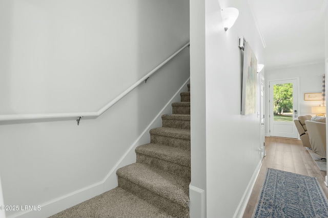 277 Pleasant Point Dr, Beaufort, SC 29907 - staircase featuring baseboards and wood finished floors