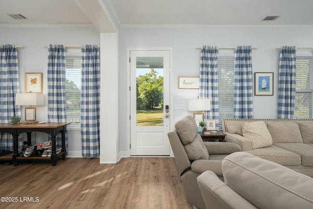 277 Pleasant Point Dr, Beaufort, SC 29907 - living room with wood finished floors, crown molding, and baseboards
