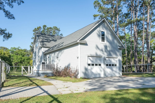 277 Pleasant Point Dr, Beaufort, SC 29907 - view of side of property with concrete driveway, roof with shingles, and an attached garage