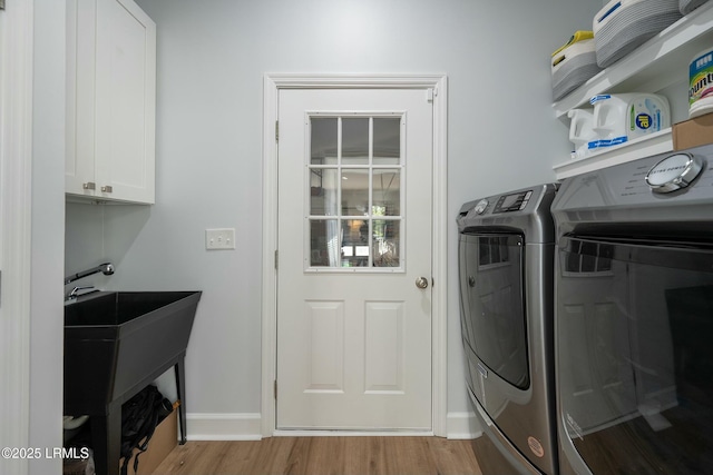 277 Pleasant Point Dr, Beaufort, SC 29907 - washroom with cabinet space, wood finished floors, independent washer and dryer, and baseboards