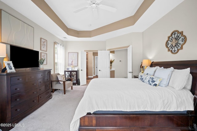 56 Waterford Dr, Bluffton, SC 29910 - bedroom with light colored carpet, a tray ceiling, and a ceiling fan