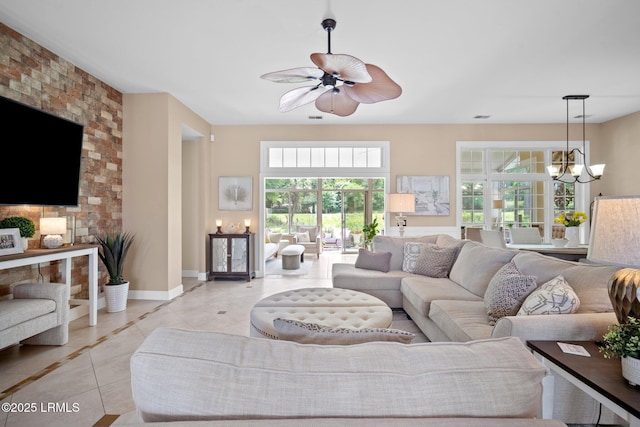 56 Waterford Dr, Bluffton, SC 29910 - living room with light tile patterned floors, a chandelier, ceiling fan, and inlaid floor details