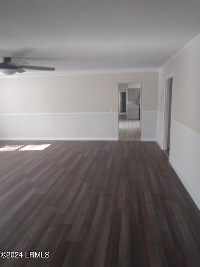 unfurnished room featuring ornamental molding, dark hardwood / wood-style floors, and ceiling fan