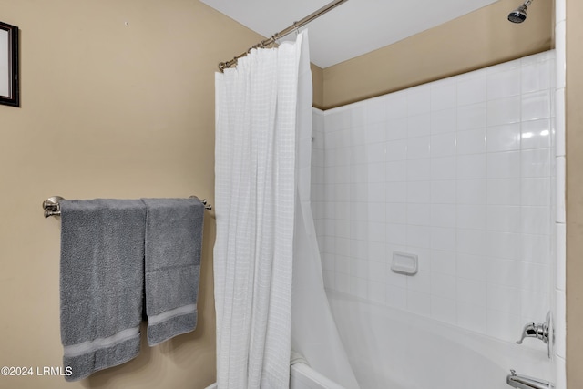 bathroom featuring shower / bathtub combination with curtain