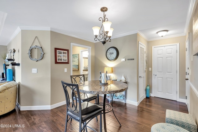 dining space featuring dark wood-type flooring, ornamental molding, and a chandelier