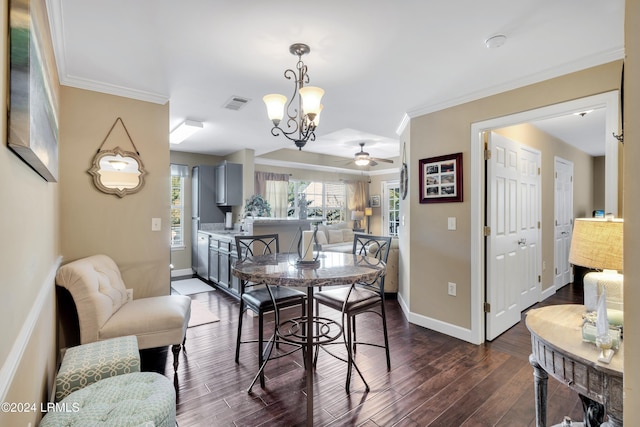 dining space featuring crown molding, dark wood-type flooring, and ceiling fan with notable chandelier