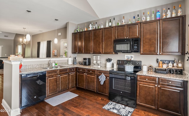 kitchen with sink, decorative light fixtures, vaulted ceiling, kitchen peninsula, and black appliances